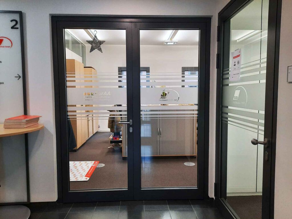 DGB-Rechtschutz-Eingangsbeschriftung-mit-Glasdekor-Streifendekor-in-Frankfurt-am-Main,-mit-Folienplott-negativ-ausgelassen Glasdekorfolie als Sichtschutz für Büroflächen in Frankfurt Westend